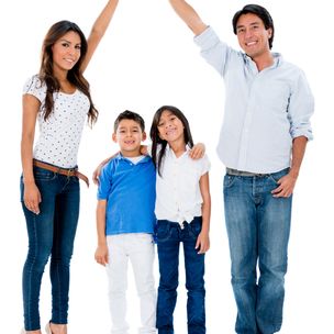 Happy family in a safe home - isolated over white background